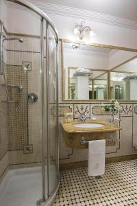 a bathroom with a sink and a glass shower at Liberty Hotel in Catania