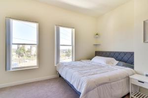 a bedroom with a bed and two windows at Portland Apartment about 1 Mi to Downtown! in Portland