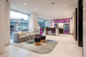 a store lobby with a couch and a table at YOTEL Porto in Porto