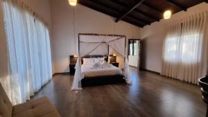 a bedroom with a bed with a canopy at The Ridge House in Kandy