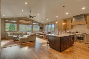 a kitchen and living room with a couch and a table at Four Seasons at Tahoe Donner - Gorgeous 4 BR Private Hot Tub- Pool Table- Amenity Access in Truckee