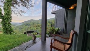 a porch with a bench and a view of the mountains at The Ridge House in Kandy