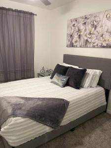 a bedroom with a large bed with pillows on it at Midtown Getaway in Houston