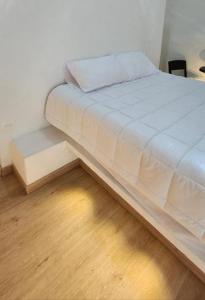 a bed in a room with a wooden floor at Casa Iglú in Santa Sofía