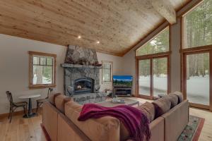 a living room with a couch and a fireplace at Majestic Woods at Tahoe Donner - High End Craftsman w Game Room, Hot Tub, Amenity Access in Truckee