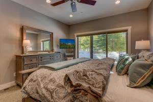 a bedroom with a bed and a dresser with a mirror at Mountain Jewel in Tahoe Donner - Beautiful 4 Bedroom w Hot tub, Access to HOA Amenities in Truckee
