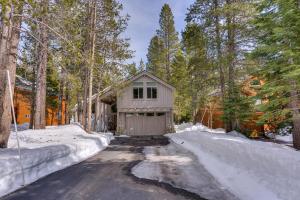 a small house in the woods in the snow at Mountain Jewel in Tahoe Donner - Beautiful 4 Bedroom w Hot tub, Access to HOA Amenities in Truckee