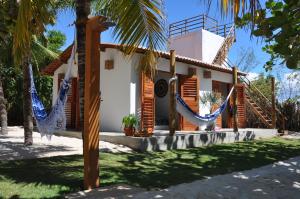 a house with hammocks in front of it at Casa Mandakarú in Icapuí