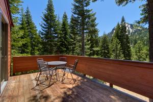 a patio with a table and chairs on a deck at On the Edge at Alpine Meadows - Fireplace- Mountain Views- Great Location! Shuttle Service! in Olympic Valley