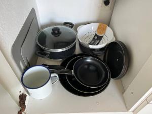 a group of pots and pans sitting in a drawer at Tranquilidad, playa y naturaleza in José Ignacio