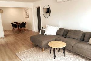 a living room with a couch and a table at Spacious Unit in Convenient Location in Yarrawonga