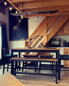 a dining room with a table with skis on the wall at Appartement 6-8 personnes à 3 minutes des pistes in Peisey-Nancroix
