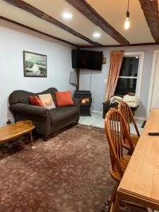 a living room with a couch and a table at The Apartment at Sky Hollow in Rochester