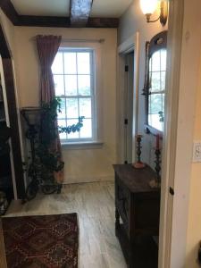 a living room with a window and a table at The Apartment at Sky Hollow in Rochester
