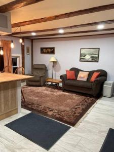 a living room with a couch and a table at The Apartment at Sky Hollow in Rochester