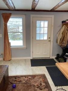 a room with a white door and a window at The Apartment at Sky Hollow in Rochester