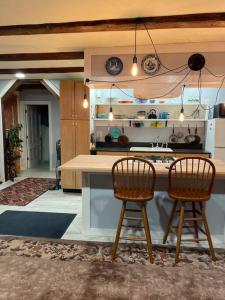 a kitchen with two chairs and a kitchen counter at The Apartment at Sky Hollow in Rochester