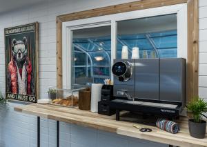 a counter top with a microwave and a window at August Jack Inn in Squamish