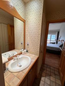 a bathroom with a sink and a mirror at Cozy 2 bedrooms condo with stunning Mont Tremblant mountain and lakeview in Mont-Tremblant +16 photos
