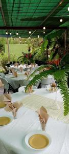 a group of tables with white table cloths on them at Camping D'Tente Paradise in Saint-Louis