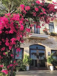 Un bâtiment avec des fleurs roses sur lui dans l'établissement Elysinam Boutique Hotel Ha Long, à Hạ Long