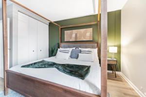 een slaapkamer met een groot bed met een houten frame bij Downtownkingrooftopfitnesstop Flr City View in Oak Park