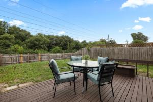 a patio with a table and chairs on a deck at Comfort & Convenience 3bd, 15 Near Hwy & Mall in Bolingbrook