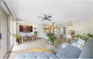 a living room with a blue couch and a table at Mari Court Resort in Gold Coast