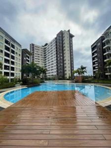 a large swimming pool in a city with tall buildings at Avida Iloilo Tower 1 Unit 324 Floor Pool View in Iloilo City