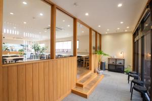 a lobby with wooden walls and a dining room at Yawarano-yu MARUYA For women only in Ise