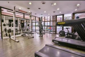 a gym with tread machines and a treadmill at Studio Living Quality Jardins in Sao Paulo