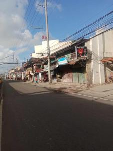 an empty street in a city with a building at WJV INN TABUNOK in Talisay