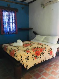 Una cama o camas en una habitación de Posada Luisa Del Valle