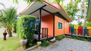 a small house with a colorful exterior at บ้านสวนชมจันทร์ กำแพงแสน 