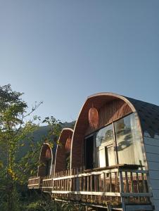 a circular house with a balcony on a hill at La Bằng Homestay in Lá Cam