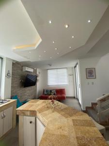 uma cozinha com um balcão e uma sala de estar em Cabaña Arrecife 07 em Coveñas