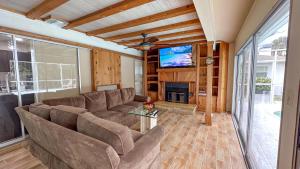 a living room with a couch and a flat screen tv at Paradise Naples Pool House in Naples