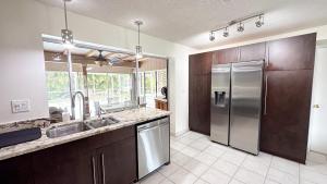 a large kitchen with a stainless steel refrigerator at Paradise Naples Pool House in Naples