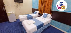 Tempat tidur dalam kamar di EWG Mahbas Hotel