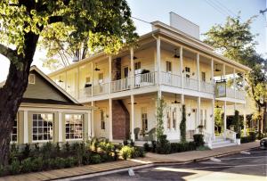 an exterior view of a large yellow house at Tallman Hotel in Upper Lake