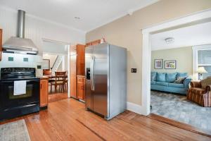 a kitchen with a stainless steel refrigerator and a living room at The Big Sanchez in Saint Augustine