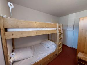 a bedroom with two bunk beds with white sheets at Appartement Autrans, 3 pièces, 6 personnes - FR-1-737-64 in Autrans