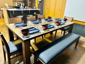a table with plates and bowls on top of it at Matsuyamachi Dotonbori Condo in Osaka