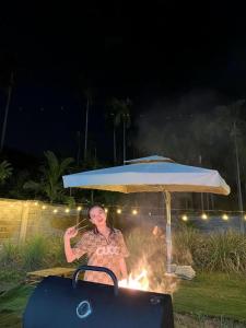 a woman is standing under an umbrella at ARECA MUINE HOMESTAY in Phan Thiet +42 photos