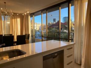 a kitchen with a counter with a view of the city at Spacious modern inner city apartment in Brisbane