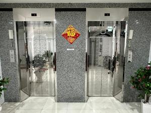a group of glass elevators in a building at Du Hung 2 Hotel in Hà Tiên