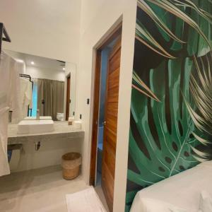 a bathroom with a large sink and a large mirror at Bahandi Hotel in General Luna +26 photos