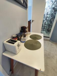 a white counter with a toaster on top of it at Loft 37 Centro histórico in São Paulo