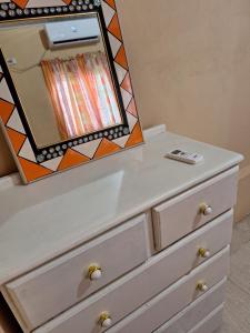a dresser with a mirror on top of it at psalms in Cunupia Village