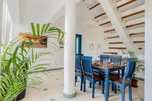 a dining room with a blue table and chairs at HideAway 2BHK Duplex Villa, North Goa (STU) in Mapusa